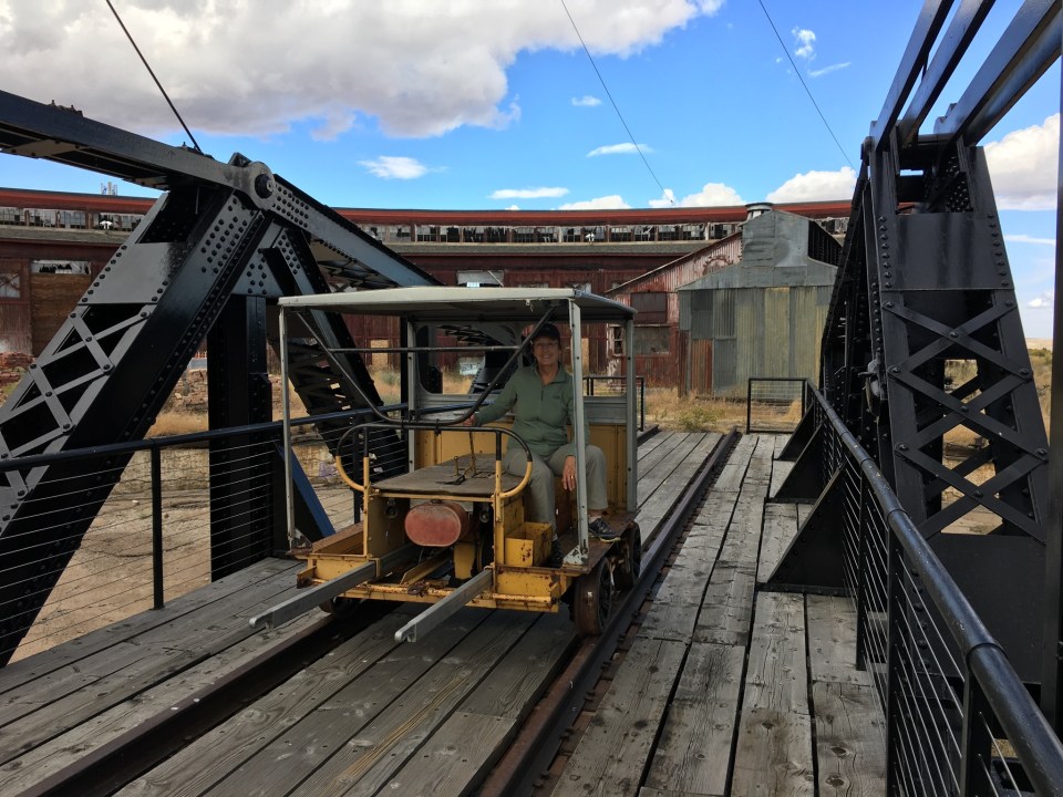 Judy driving, railroad roundhouse, Evanston, Wyoming